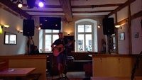 a man playing an acoustic guitar in a restaurant